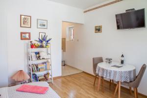a dining room with a table and a book shelf at Apartments Heaven in Cetinje
