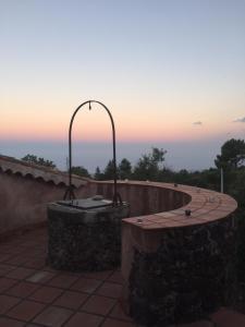 a hot tub on top of a building with a sunset at Intero alloggio - Casale a Sant'Alfio immerso nel verde in SantʼAlfio