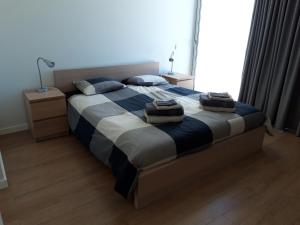 a bedroom with a large bed with towels on it at Sea Sagres in Sagres