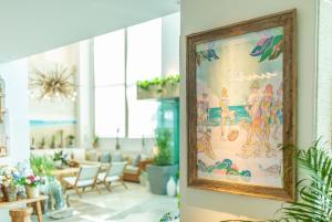 a painting hanging on a wall in a lobby at Hayama Umino Hotel in Hayama