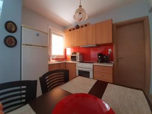 a kitchen with a table and chairs and a refrigerator at Apartment with Balcony and Parking in Kavala