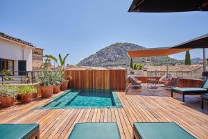 a deck with a swimming pool on top of a house at Mon Boutique Hotel in Pollença