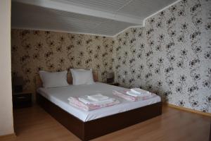 A bed or beds in a room at Exotic Guest House