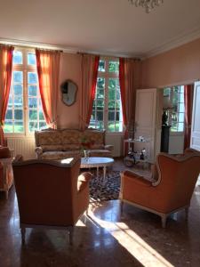 un soggiorno con 2 sedie e un divano di L'Hermitage a Saint-Martin-des-Champs