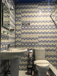 a bathroom with a toilet and a sink at Golden House in Anaklia