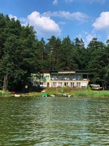 a house on the shore of a lake at Gościniec Rospuda 2 in Augustów