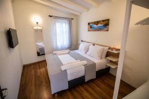 A bed or beds in a room at Levkosh Apartments at Lefkada's Heart
