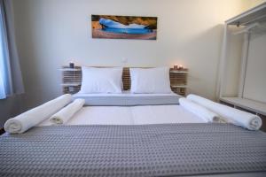 A bed or beds in a room at Levkosh Apartments at Lefkada's Heart