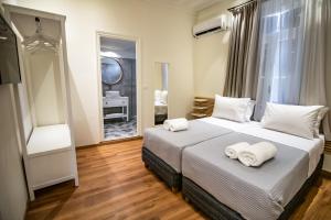 A bed or beds in a room at Levkosh Apartments at Lefkada's Heart