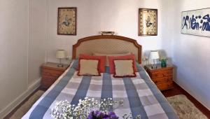 a bedroom with a bed with red and blue pillows at Beachfront oasis in Costa del Sol. in Caleta De Velez +31 photos
