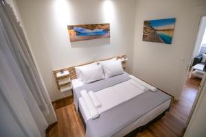 A bed or beds in a room at Levkosh Apartments at Lefkada's Heart