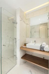 a bathroom with a sink and a shower at Ionian Garden Villas - Villa Pietra in Benitses