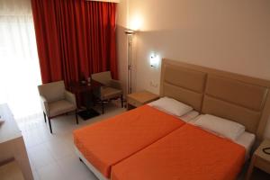 a hotel room with a bed and a table and chairs at KOLYMBIA SKY HOTEL in Kolymbia +21 photos