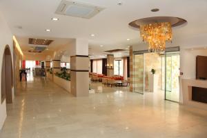 a large lobby with a chandelier in a building at KOLYMBIA SKY HOTEL in Kolymbia