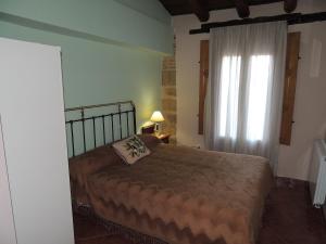 a bedroom with a large bed and a window at Las Bodegas Del Gilo in Valdealgorfa