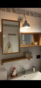 a bathroom with a sink and a mirror above a sink at Elfoghiro' in Ateleta