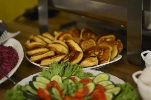 a table with three plates of different types of bread at Four Seasons Riverside in Kutaisi