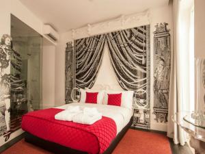 a bedroom with a large bed and a large window at Teatro Boutique Rooms & Suites in Lisbon