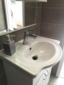 a white sink in a bathroom with a mirror at Apartment Ivka in Dubrovnik