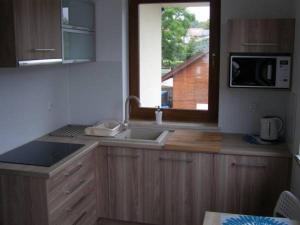 a kitchen with a sink and a window at Pokoje gościnne GRYF in Rewal +19 photos