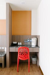 a red chair sitting in front of a kitchen counter at The Stay Inn in Kenting