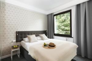 a bedroom with a bed with a hat on it at Vrestpoint in Gdańsk