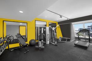 a gym with treadmills and chairs in a building at Leva Hotel and Suites, Opposite Downtown in Dubai