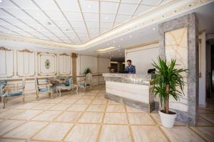 a man standing at a counter in a lobby at Palde Hotel & Spa in Istanbul