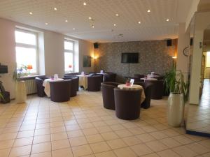 a restaurant with tables and chairs in a room at Hotel Krone in Bad Münster am Stein-Ebernburg