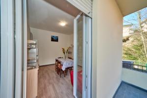 a dining room with a table and a window at Casa della nonna in Abbadia Lariana