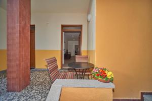 a table and two chairs and a table with flowers at Casa della nonna in Abbadia Lariana