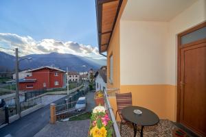 a balcony with a table and a view of a street at Casa della nonna in Abbadia Lariana