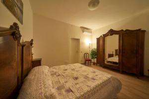 a bedroom with a bed and a large mirror at Casa della nonna in Abbadia Lariana