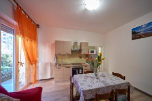 a kitchen with a table with a vase of flowers on it at Casa della nonna in Abbadia Lariana