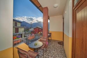 a balcony with a table and chairs and a view at Casa della nonna in Abbadia Lariana