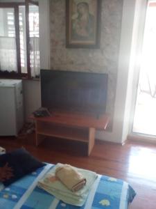 a bedroom with a bed with a table in it at Apartman i Sobe Čule Cres in Cres