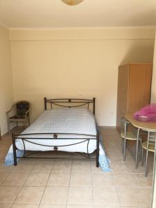 a bedroom with a bed and a table at Angela apartments in Lefkada Town