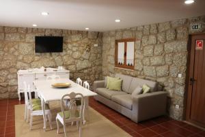 a living room with a couch and a table at Quinta do Perguntouro in Barrosas