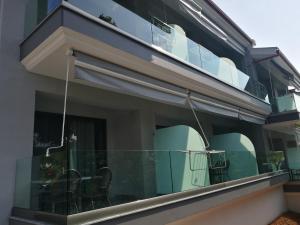 a balcony with chairs and tables on it at 4- you Family in Metamorfosi