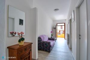 a living room with a chair and a table at Casa della nonna in Abbadia Lariana