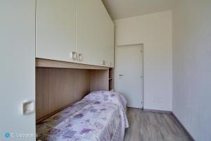 a small bedroom with a bed and a closet at Casa della nonna in Abbadia Lariana