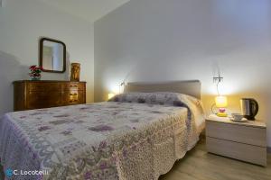 a bedroom with a bed and a dresser and a mirror at Casa della nonna in Abbadia Lariana