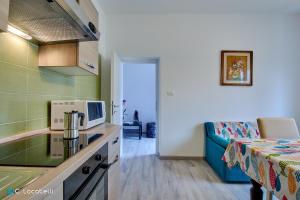 a kitchen with a sink and a couch in a room at Casa della nonna in Abbadia Lariana