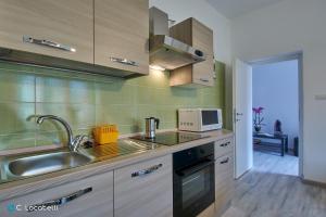 a kitchen with a sink and a microwave at Casa della nonna in Abbadia Lariana