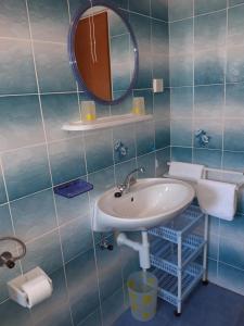 a bathroom with a sink and a mirror at Apartments Renata in Rab