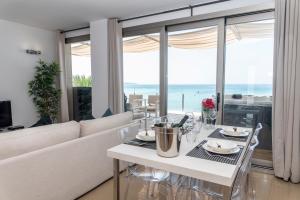 a dining room table with a glass of wine on it at Apartaments Delfin in Playa de Palma