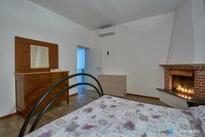 1 dormitorio con 1 cama y chimenea en Casa della nonna, en Abbadia Lariana