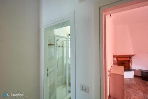 a glass door in a room with a fireplace at Casa della nonna in Abbadia Lariana