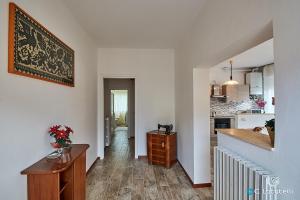 a kitchen and a living room with a table in a room at Casa della nonna in Abbadia Lariana