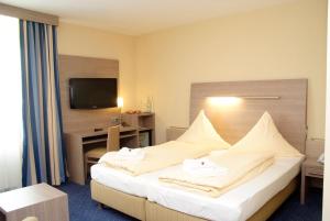 Postel nebo postele na pokoji v ubytování Hotel Bügener + 23 fotografií